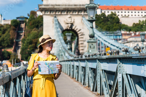 Female tourist with a map exploring Budapest