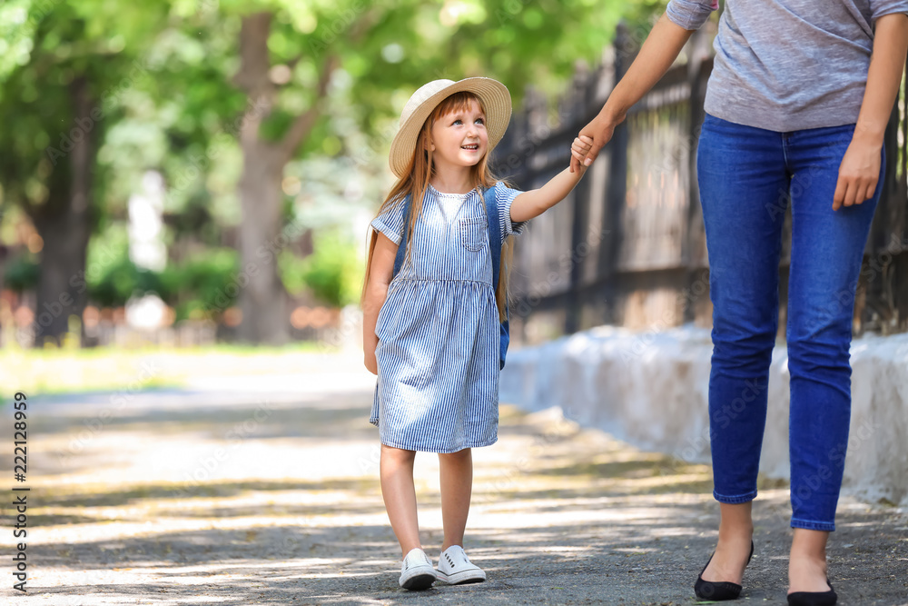 Fototapeta premium Cute little girl going to school with her mother