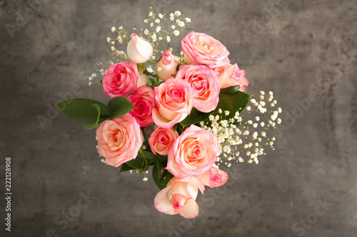Bouquet of beautiful roses on grey background