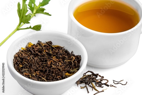 Cup of Green Tea with Dried Leaves Tea in Bowl