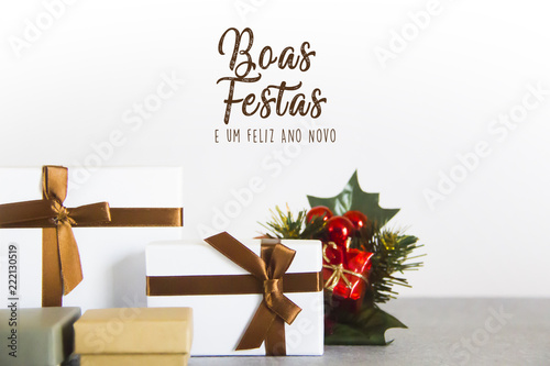 Christmas gift boxes on white background, with merry christmas text in portuguese 