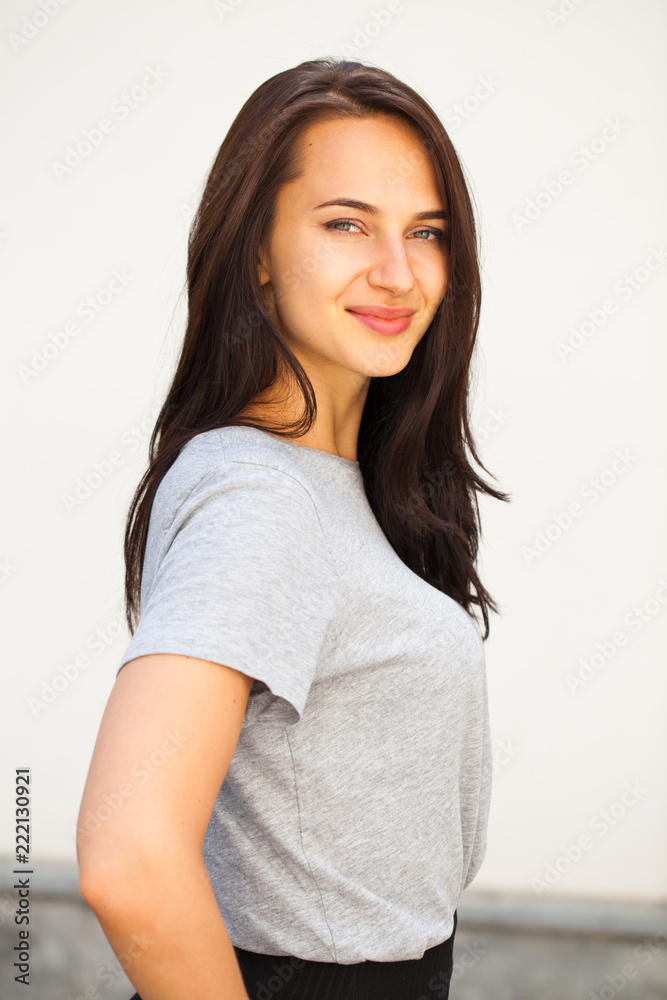 Happy brunette woman in gray t-shirt Happy brunette woman in gray t-shirt