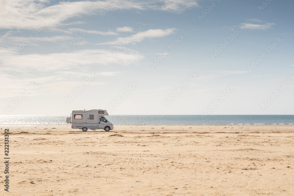 Campervan parked on the beach