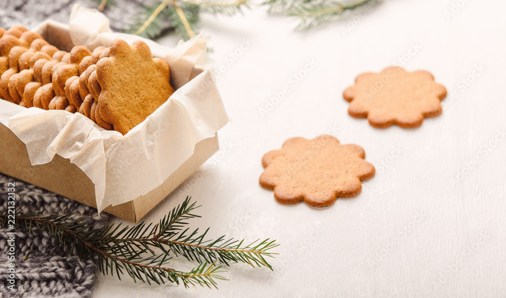 Sweet thin ginger cookies in a gift box on white background on a plaid. Festive pastry, cozy home. Sweet thin ginger cookies in a gift box on white background on a plaid. Festive pastry, cozy home.