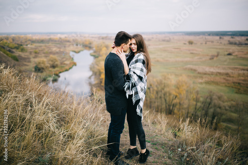 Lovers walking in the mountains. Autumn love of two happy people. Lovebirds are embracing. Soft focus.