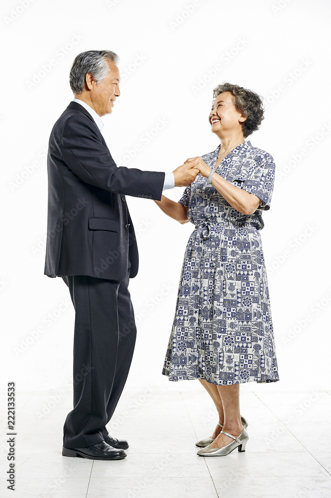 Grandfather and grandmother hand in hand together dancing cheerfully in white background Grandfather and grandmother hand in hand together dancing cheerfully in white background