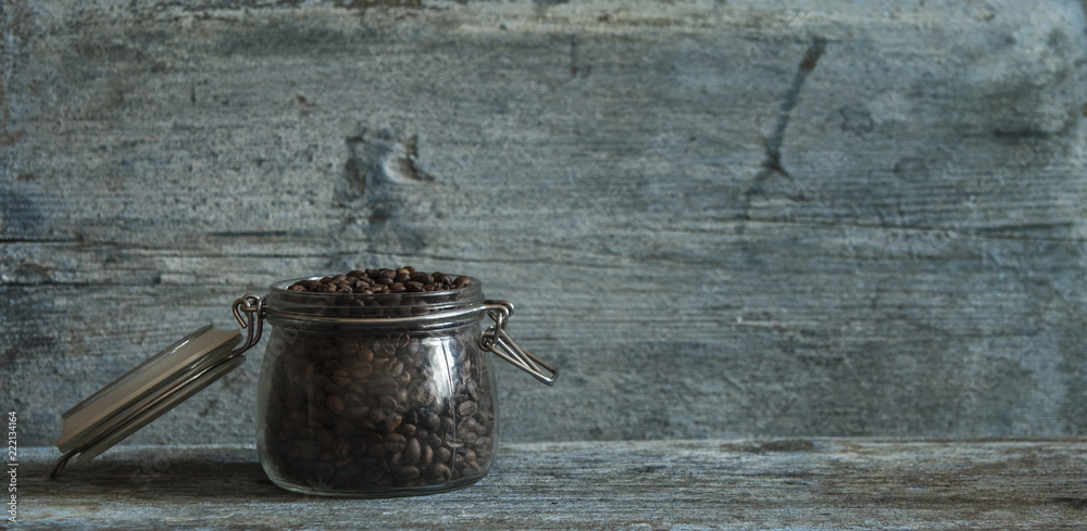 Coffee bean in glass jar on wooden table. Coffee bean in glass jar on wooden table.