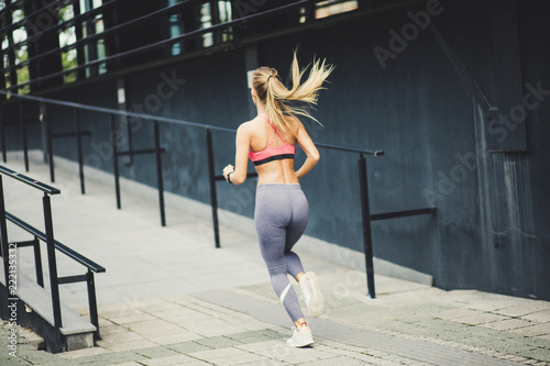 Young beautiful blonde women running.   From back. © liderina