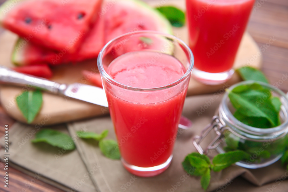 Glass with fresh watermelon smoothie on table Glass with fresh watermelon smoothie on table