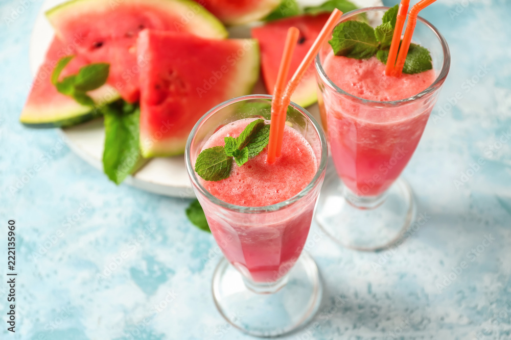 Glasses with fresh watermelon smoothie on light table Glasses with fresh watermelon smoothie on light table
