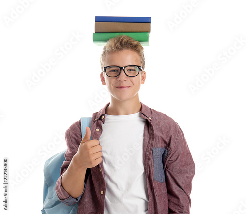 Teenage boy with stack of b...