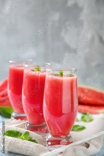 Glasses with fresh watermelon smoothie on table