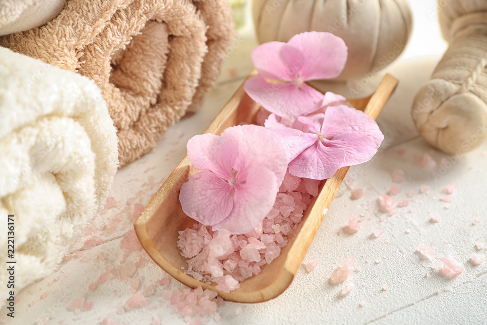 Sea salt with hydrangea flowers on light table Sea salt with hydrangea flowers on light table