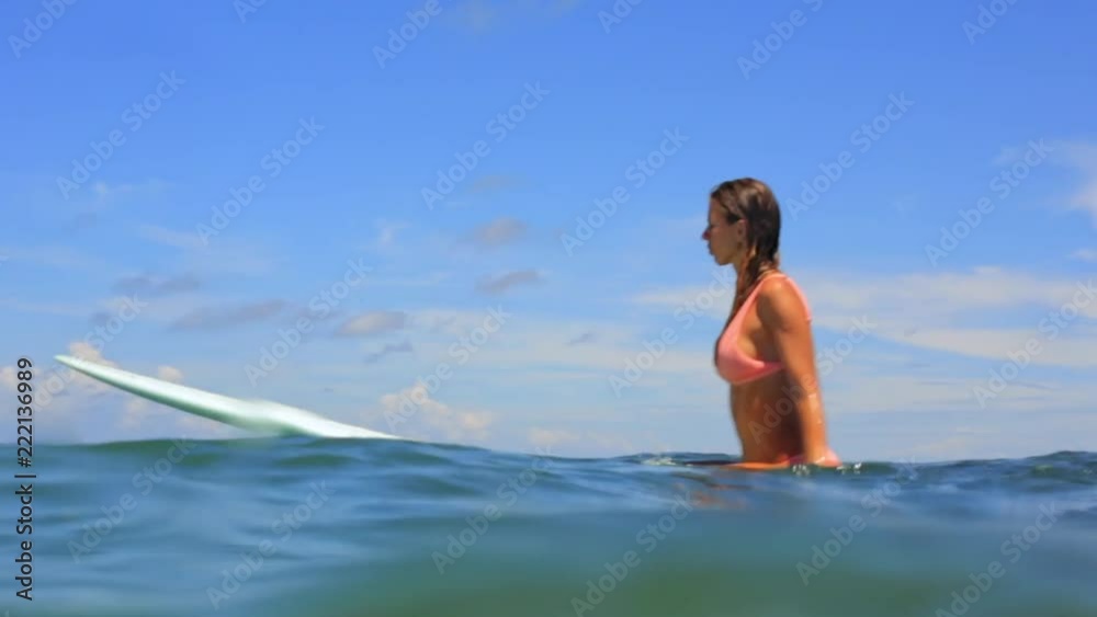 Beautiful young surfer woman in sexy pink bikini make splash on surf long board. Big waves in open water of ocean. Modern family lifestyle. People water sport adventure camp. Extreme summer vacation. Beautiful young surfer woman in sexy pink bikini make splash on surf long board. Big waves in open water of ocean. Modern family lifestyle. People water sport adventure camp. Extreme summer vacation.