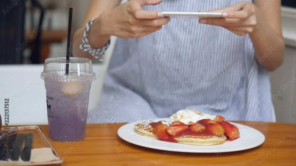Close up young asian woman take a photo pancake at cafe. Technology and social networks concept. Close up young asian woman take a photo pancake at cafe. Technology and social networks concept.