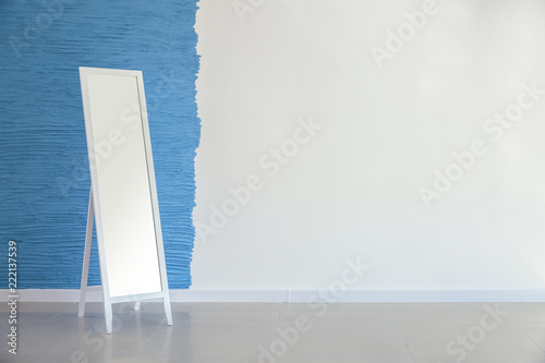 Large mirror near color wall