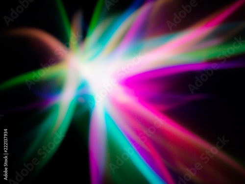 Background composed of multicolored light effects on black background.