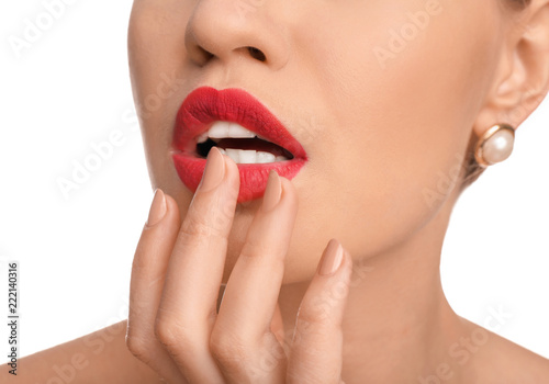 Beautiful young woman with bright red lipstick on white background  closeup