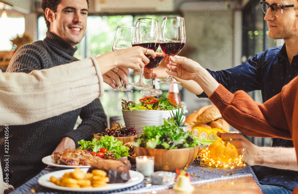 Group of young people celebrating Christmas party dinner with clinking glass of wine and selfie Group of young people celebrating Christmas party dinner with clinking glass of wine and selfie
