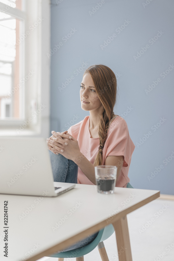 Woman at home sitting at desk with laptop Woman at home sitting at desk with laptop