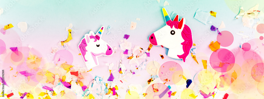A white unicorn with rainbow horn and confetti top view.
