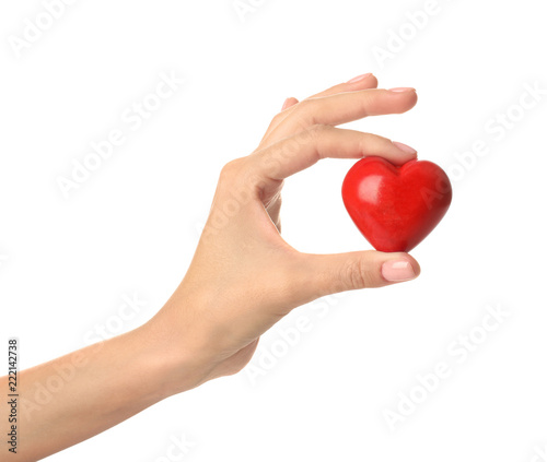 Female hand with red heart on white background