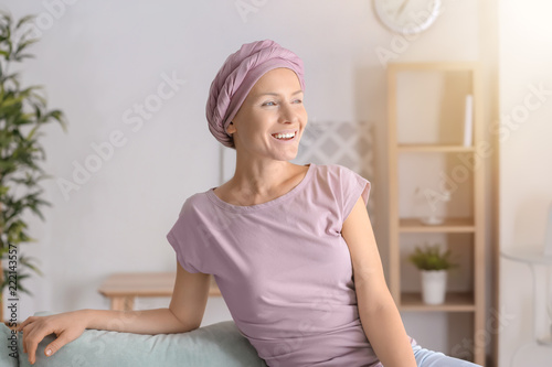 Obraz na plátně Happy woman after chemotherapy  sitting on sofa at home