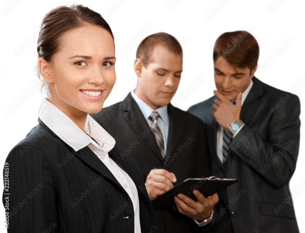 Friendly Businesswoman and Talking Collaborators in Background - Friendly Businesswoman and Talking Collaborators in Background -
