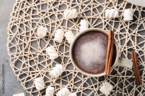 Cup of delicious cocoa and marshmallows on napkin