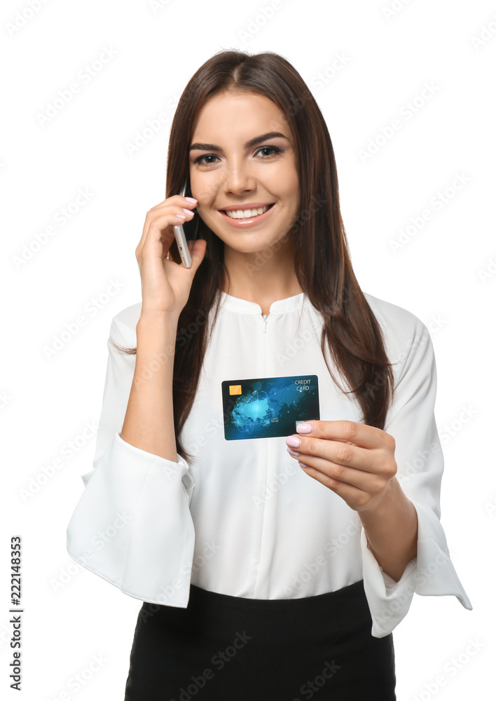 Young woman with credit card talking on mobile phone against white background. Online shopping Young woman with credit card talking on mobile phone against white background. Online shopping