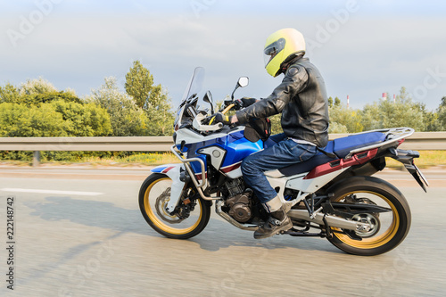 Motorcyclist riding fas his new mdern motorcycle