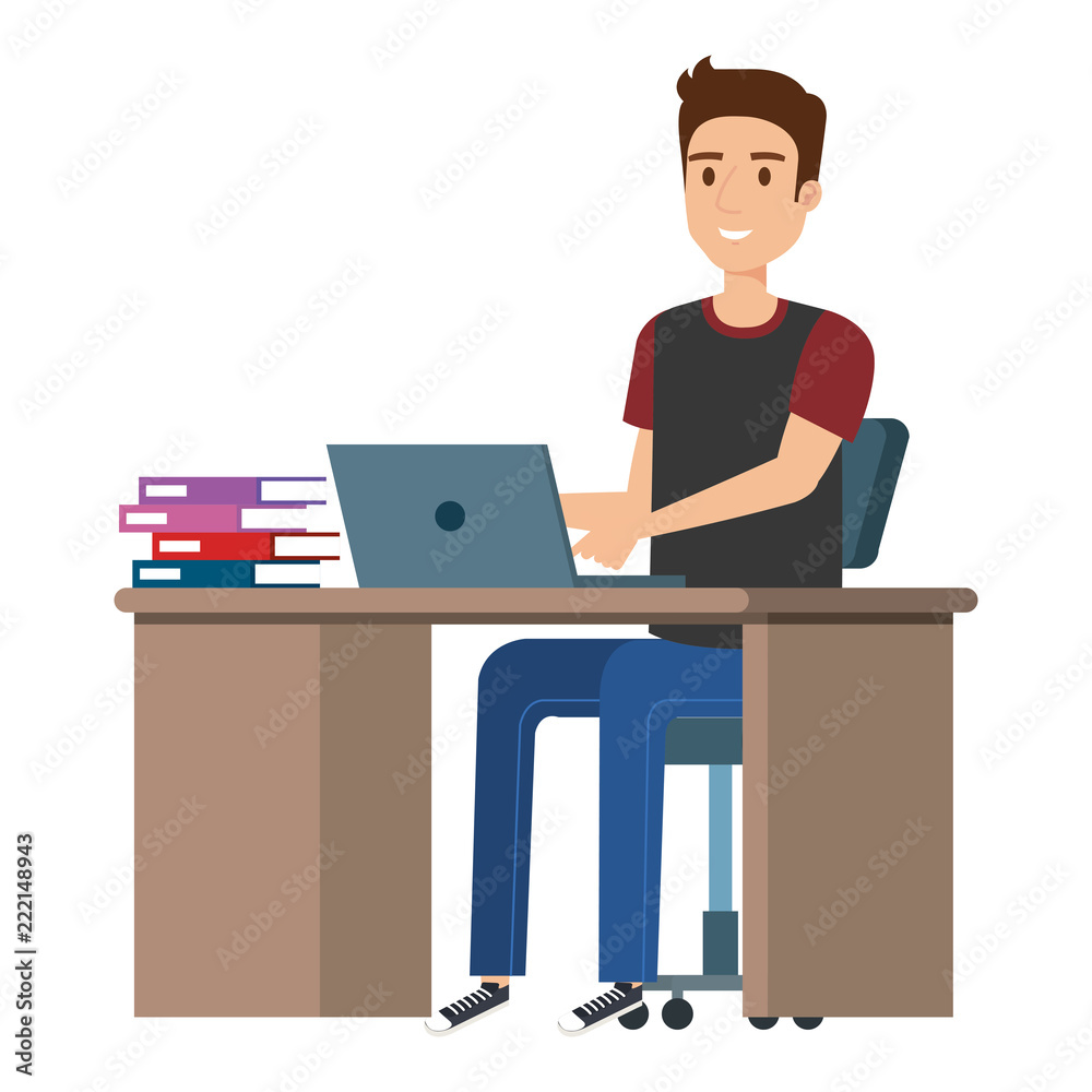 young man at desk with laptop and books young man at desk with laptop and books