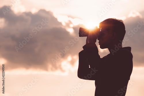 Asian man Hand Holding Binoculars / looking / watching using Binoculars with copyspace,Concept of The pursuit of profitable business in the future. photo