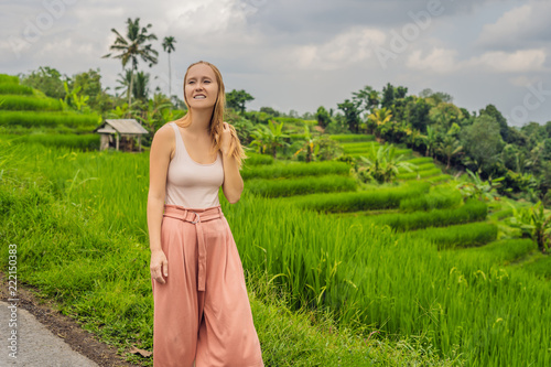 Young woman traveler on Beautiful Jatiluwih Rice Terraces against the background of famous volcanoes in Bali, Indonesia photo