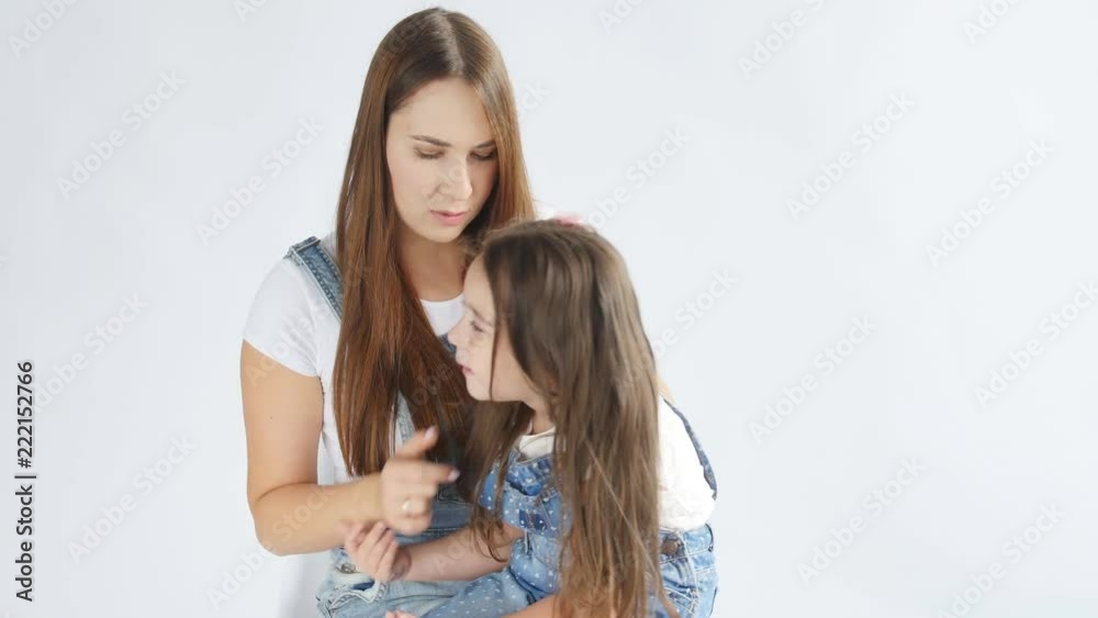 Family concept. A young mother is combing a little daughter Family concept. A young mother is combing a little daughter