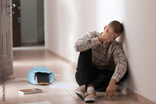 Sad teenage boy sitting on ...