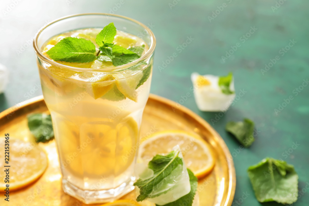 Glass of fresh lemonade on metal tray