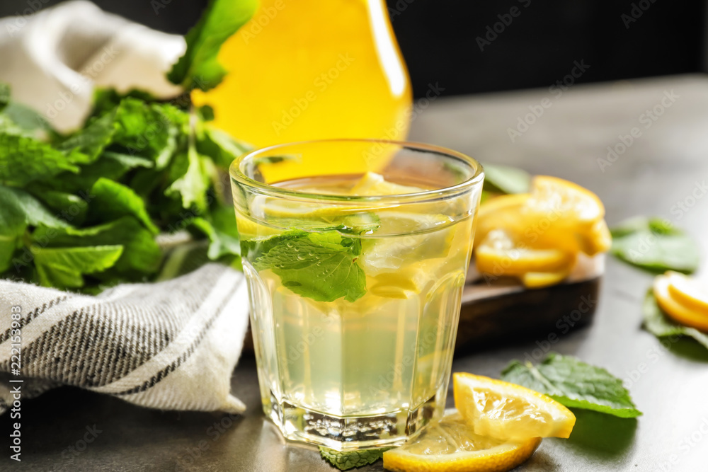 Glass of fresh lemonade on dark table Glass of fresh lemonade on dark table