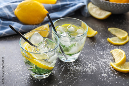 Glasses of fresh lemonade on grey table