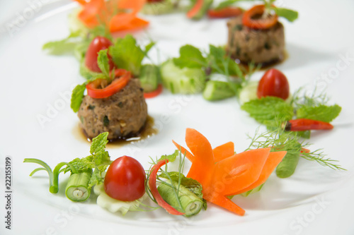 creative food design on white plate with spices and sauce
