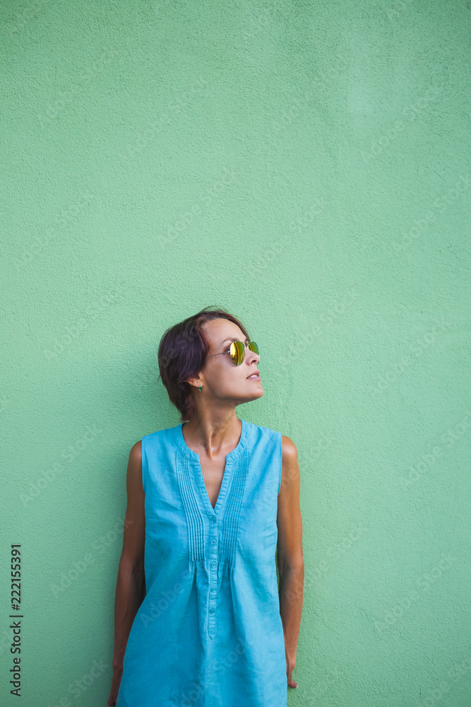 Girl on the background of a green wall. Girl on the background of a green wall.