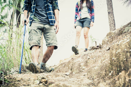 Couple hikers walking on the path on top of the mountain