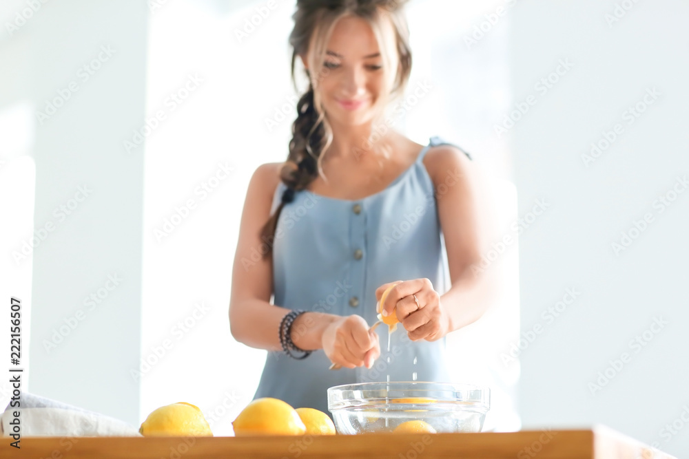 Young woman preparing fresh lemonade at home Young woman preparing fresh lemonade at home