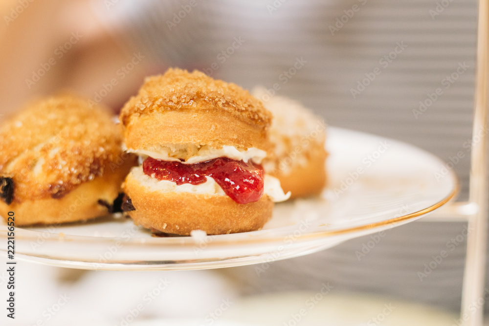 Scones with Strawberry Champagne Jam and Clotted Cream, Traditional English Tea Ceremony in Luxury Hotel Scones with Strawberry Champagne Jam and Clotted Cream, Traditional English Tea Ceremony in Luxury Hotel