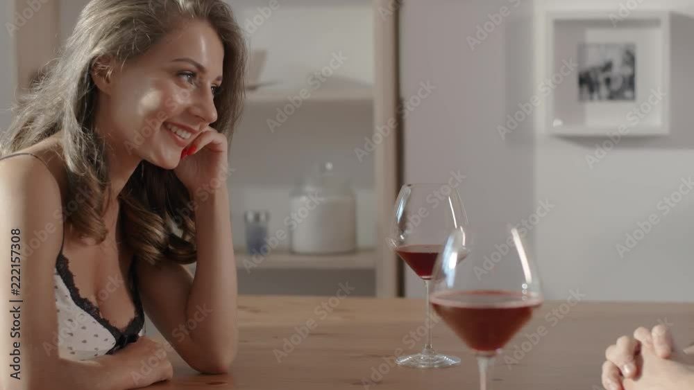 Conversation in cafe between sexy woman and man, people sits at the cafe table, hold glasses of wine in their hands and talk to each other, woman and man on a date Conversation in cafe between sexy woman and man, people sits at the cafe table, hold glasses of wine in their hands and talk to each other, woman and man on a date