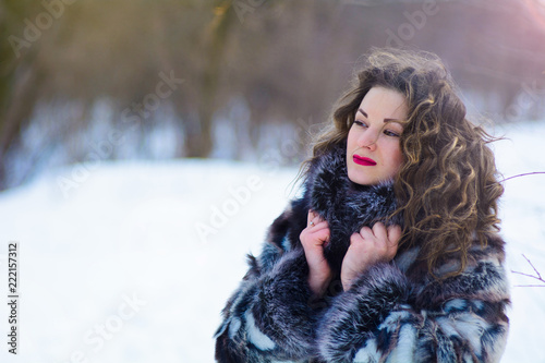 girl with curtains in winter in gray coat