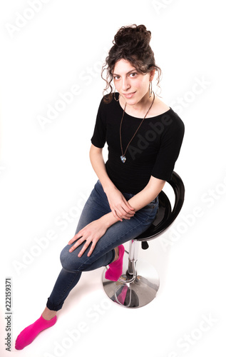 Young woman sitting on white