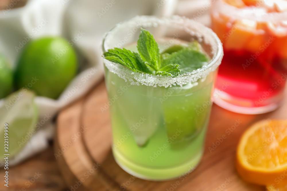Fresh summer cocktail in glass on wooden board