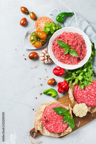 Homemade raw organic minced beef meat burger cutlet and vegetables