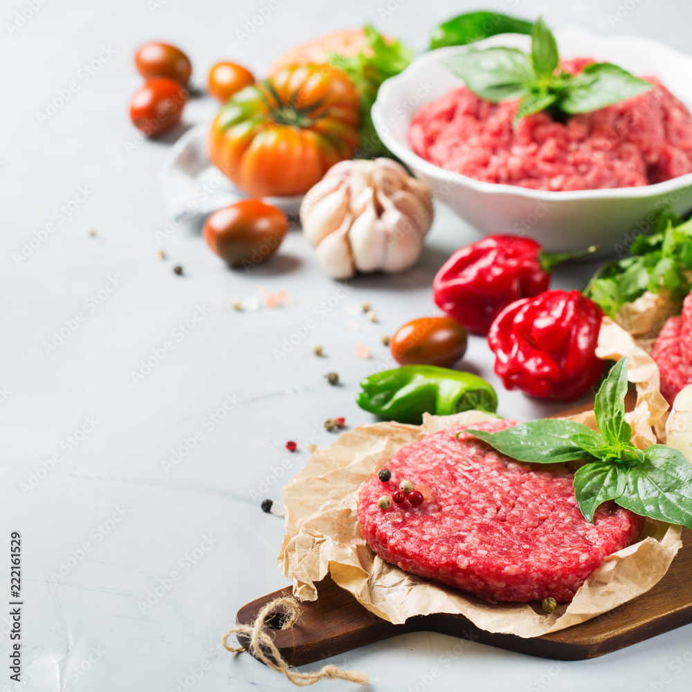 Homemade raw organic minced beef meat burger cutlet and vegetables Homemade raw organic minced beef meat burger cutlet and vegetables